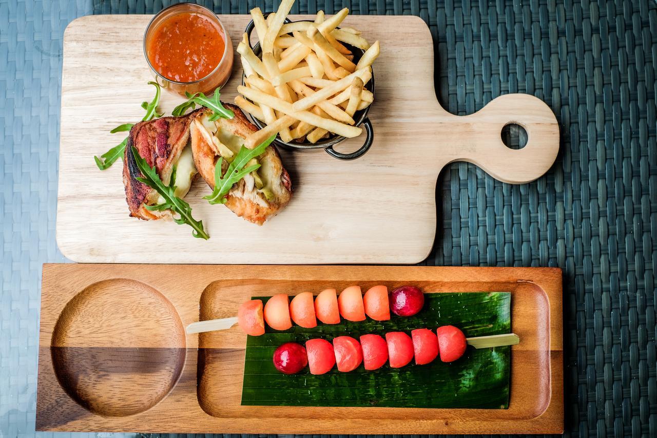 Fusion Suites Phuket Patong Экстерьер фото A wooden cutting board with a handle