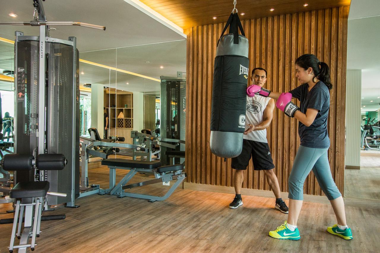 Fusion Suites Phuket Patong Экстерьер фото A woman training with a personal trainer